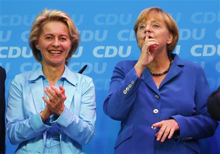 German Labour Minister Ursula von der Leyen (L) and German Chancellor and leader of the Christian Democratic Union (CDU) Angela Merkel celebrate after first exit polls in the German general election (Bundestagswahl) at the CDU party headquarters in Berlin September 22, 2013. REUTERS/Kai Pfaffenbach