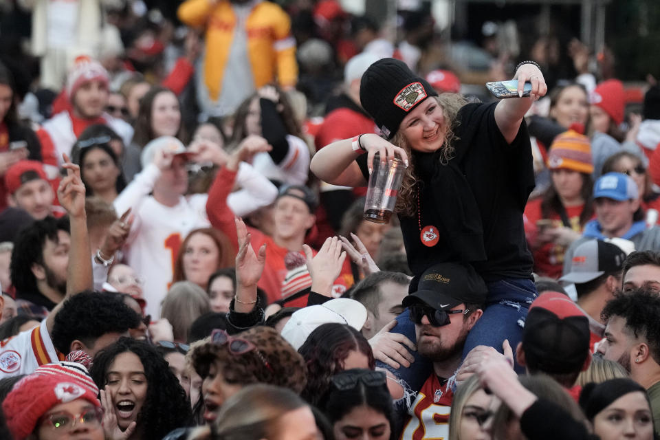 Kansas City Chiefs fans celebrate at a watch party in downtown Kansas City, Mo. after the Chiefs beat the Baltimore Ravens to win the AFC Championship NFL football game Sunday, Jan. 28, 2024. (AP Photo/Charlie Riedel)