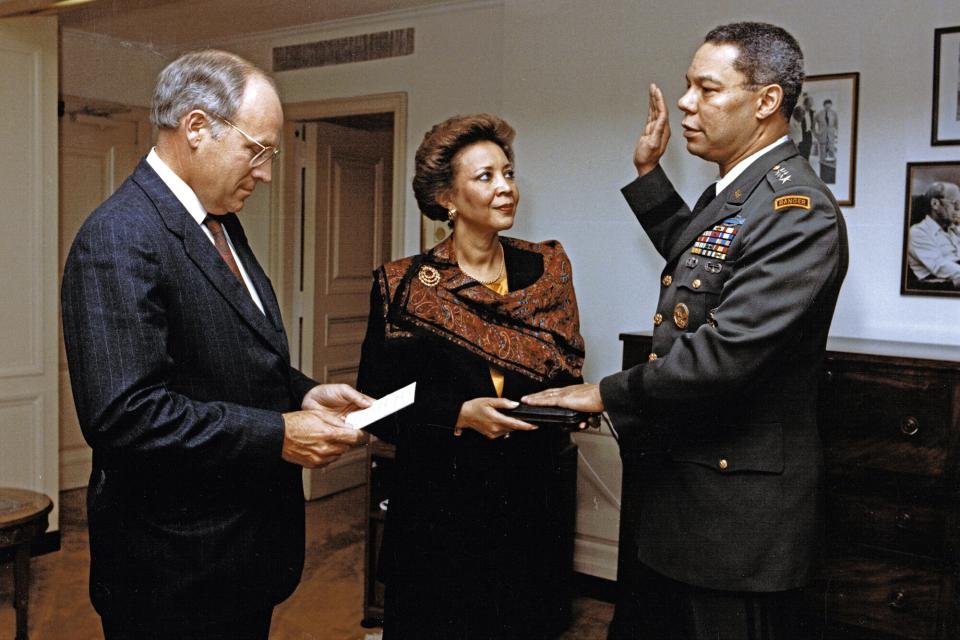 US Secretary of Defense Dick Cheney (left) administers the oath of office to General Colin L Powell (1937 - 2021) as Joint Chiefs of Staff Chairman, Washington DC, October 3, 1989. Powell's wife, Alma, is shown holding a bible. (Photo by Helene C. Stikkel/DoD via CNP/Getty Images)