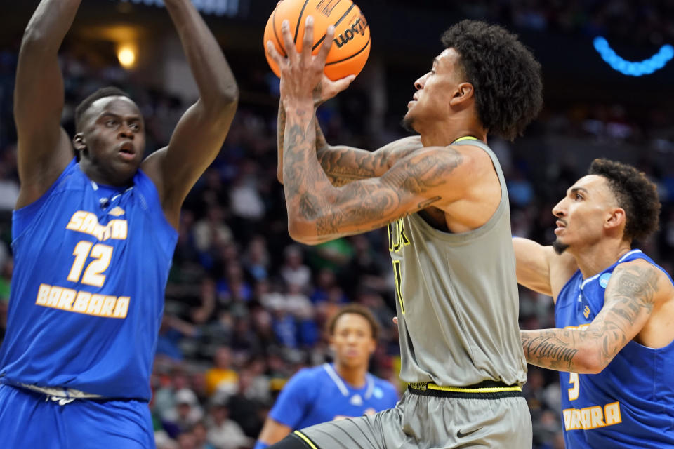 Baylor forward Jalen Bridges, center, drives to the basket as UC Santa Barbara forward Evans Kipruto, left, and forward Miles Norris defend in the second half of a first-round college basketball game in the men's NCAA Tournament, Friday, March 17, 2023, in Denver. (AP Photo/John Leyba)