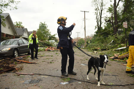 A FEMA employee surveys damage on Woodlawn Avenue following a tornado touchdown overnight in Jefferson City, Missouri, U.S. May 23, 2019. REUTERS/Antranik Tavitian