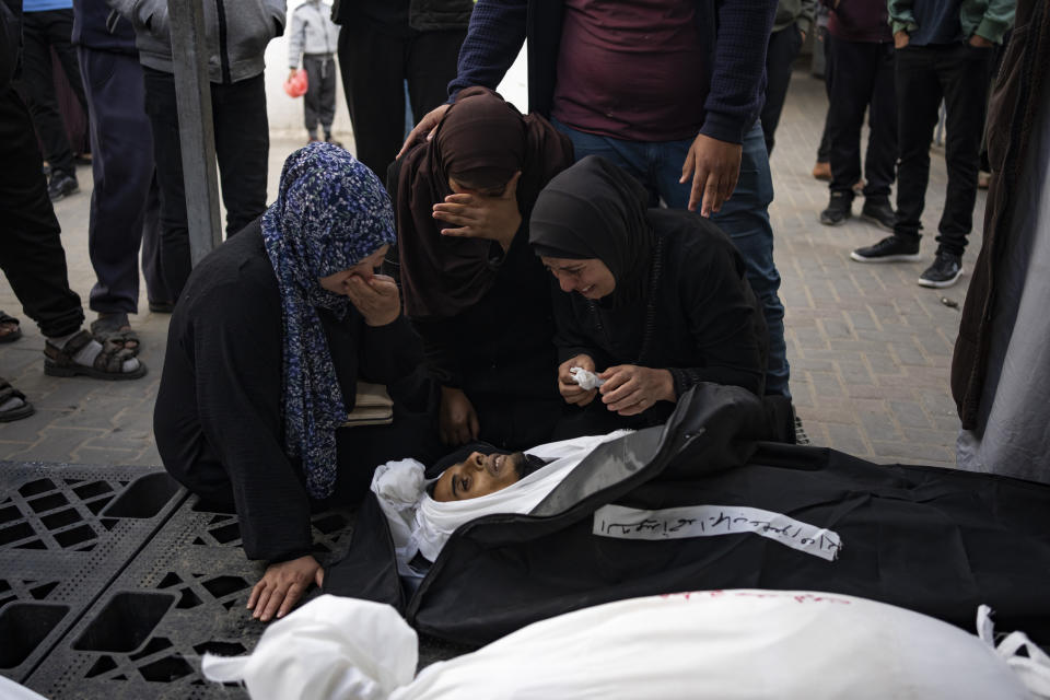 Palestinians mourn relatives killed in the Israeli bombardment of the Gaza Strip at a hospital morgue in Rafah, Tuesday, March 26, 2024. (AP Photo/Fatima Shbair)