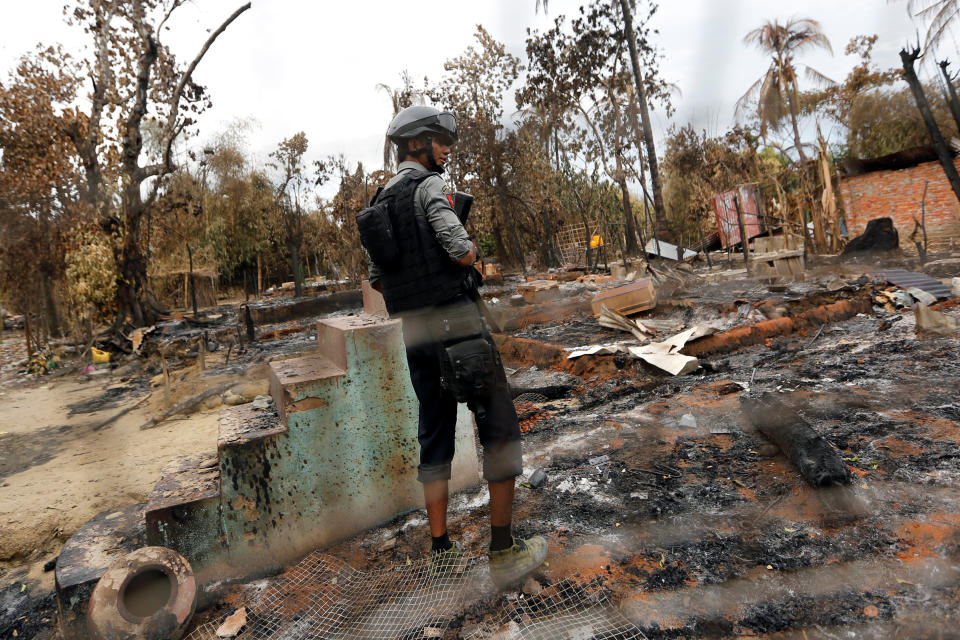 A police officer stands in a house that was burnt down during the days of violence in Maungdaw, Myanmar, Aug. 30, 2017. (Photo: Soe Zeya Tun/Reuters)