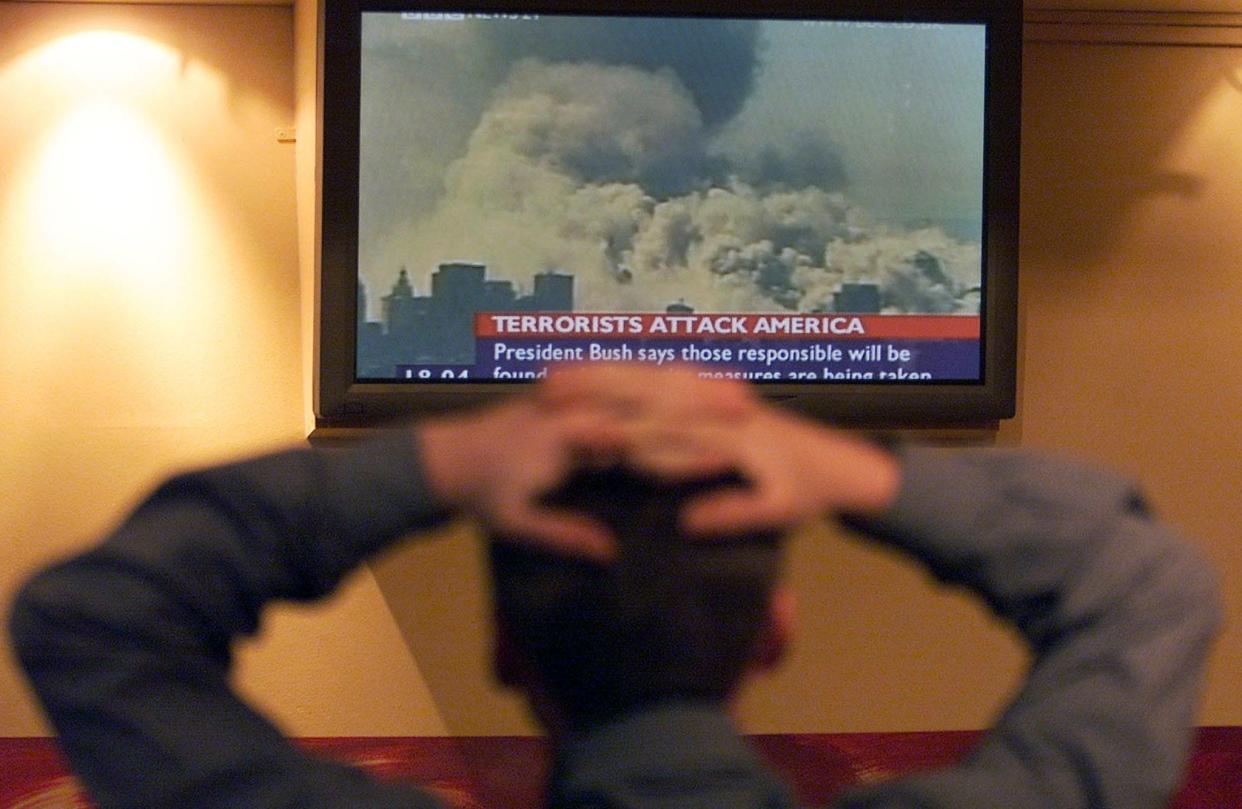 City workers in a London pub watch news of terrorist attacks on the United States September 11, 2001. Three aircraft crashed into the World Trade Centre in New York and The Pentagon in Washington in what was described as the biggest act of terrorism in history.