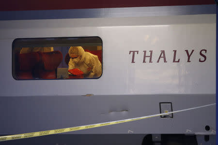 French investigating police in protective clothing collect clues inside the Thalys high-speed train where shots were fired in Arras, France, August 21, 2015. REUTERS/Pascal Rossignol