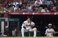 Los Angeles Angels' Shohei Ohtani sits near the dugout during the fifth inning of the team's baseball game against the Chicago White Sox on Wednesday, June 29, 2022, in Anaheim, Calif. (AP Photo/Jae C. Hong)