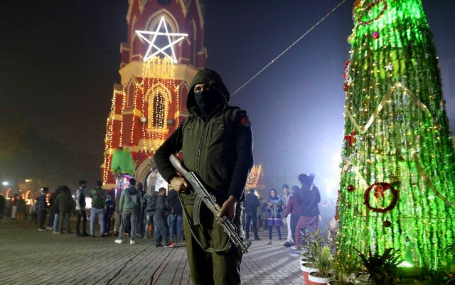 A police officer stands guard at St Anthony’s Church in Lahore (KM Chaudary/AP)