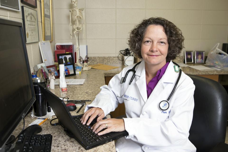 Dr. Pamela Banister poses while working at a clinic which is part of the Singing River Health System in Pascagoula, Mississippi September 26, 2013. The not-for-profit hospital system offers a menu of services that all cost $49, from school physicals to treatments for sinus infections and rashes. On bigger-ticket items, the hospital offers a 40 percent discount to patients who can pay cash at the time of service. Despite the clinic offering discounts for treatments paid in cash, many in the area still cannot afford the tests they need or visits with a specialist. As Americans across the nation begin to find out what Obamacare has in store for them, many of Mississippi's most needy will find out the answer is nothing, since the state decided not to expand the Medicaid program for the poor under President Barack Obama's Affordable Care Act. Picture taken September 26. To match Feature USA-HEALTHCARE/MISSISSIPPI REUTERS/Lyle Ratliff (UNITED STATES - Tags: HEALTH BUSINESS SOCIETY POVERTY)