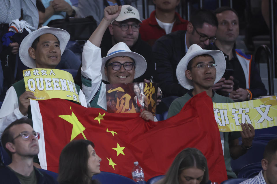 Supporters of Zheng Qinwen of China react during her semifinal against Dayana Yastremska of Ukraine at the Australian Open tennis championships at Melbourne Park, Melbourne, Australia, Thursday, Jan. 25, 2024. (AP Photo/Asanka Brendon Ratnayake)