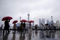 People wearing masks are seen at the Bund in Shanghai