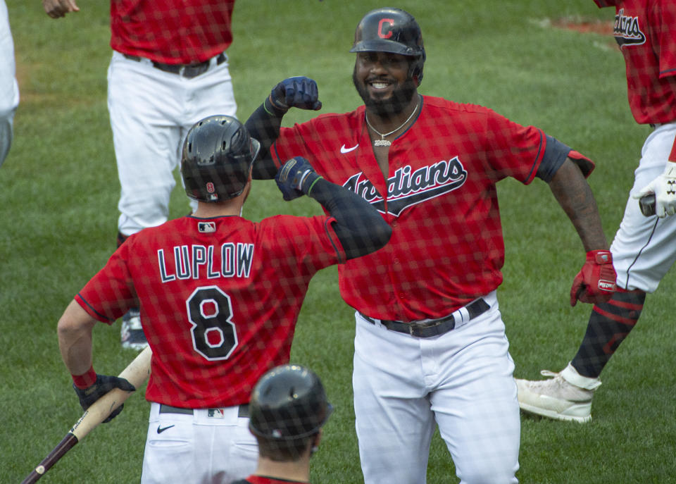 Cleveland Indians' Franmil Reyes, right, celebrates with Jordan Luplow (8) after hitting a three-run home run off Pittsburgh Pirates relief pitcher Geoff Hartlieb during the sixth inning of a baseball game in Cleveland, Sunday, Sept. 27, 2020. (AP Photo/Phil Long)