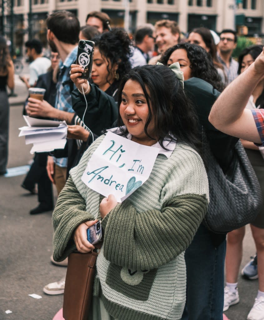 A woman in New York introduced herself through the portal with a sign that read: “Hi, I’m Andrea.” Stephen Yang