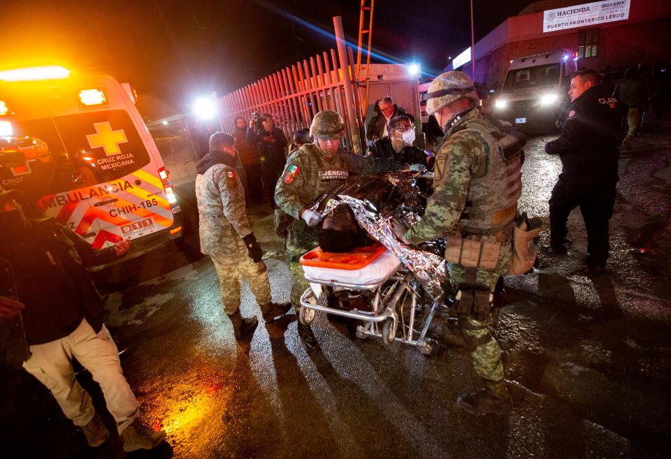 A migrant is rushed to the hospital after a fire broke out at a Mexican immigration detention center in Juarez on Monday, March 27, 2023.