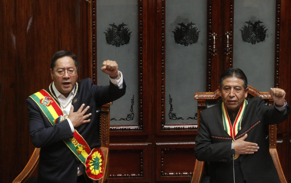 Bolivia's new President Luis Arce, left, and Vice President David Choquehuanca sing the national anthem on their inauguration day at Congress in La Paz, Bolivia, Sunday, Nov. 8, 2020. (AP Photo/Jorge Mamani)