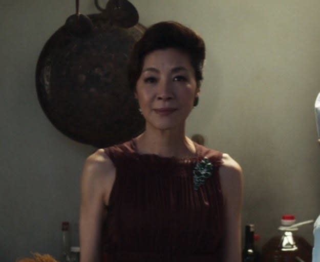 Michelle Yeoh as Eleanor meets Nick's girlfriend, Rachel, in her kitchen