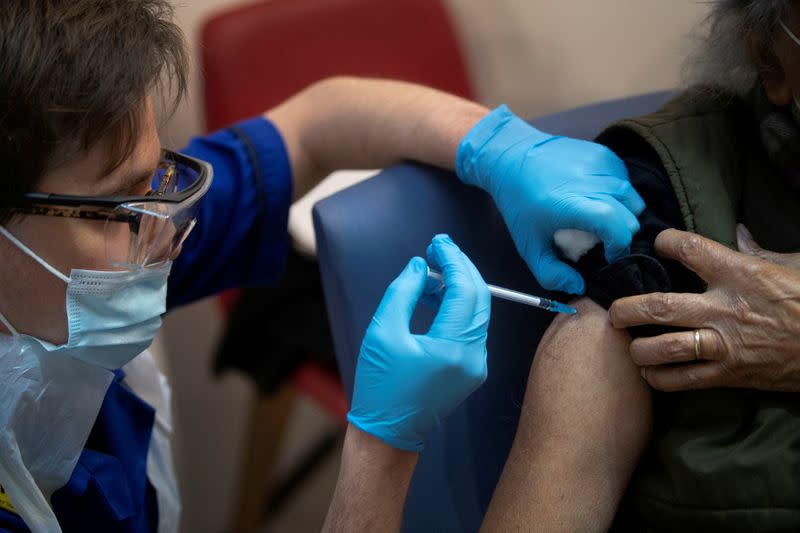 FILE PHOTO: A man receives the first of two Pfizer/BioNTech COVID-19 vaccine jabs, at Guy's Hospital in London