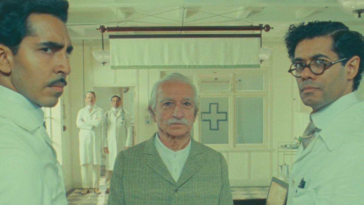  Dev Patel and Richard Ayoade look perplexed in front of Ben Kingsley in The Wonderful Story of Henry Sugar. 