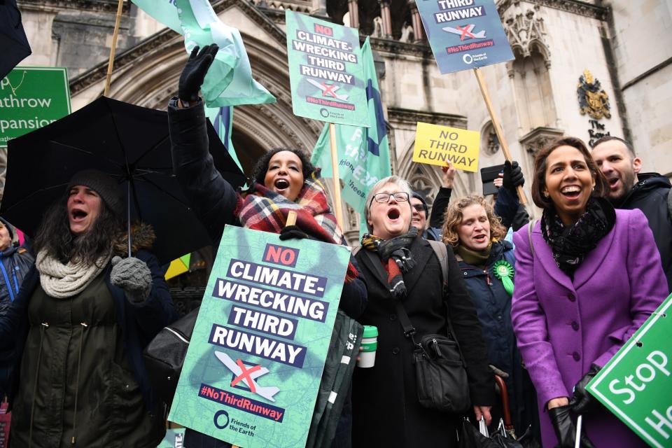 Campaigners celebrate outside the Royal Courts of Justice (PA)