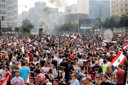 Smoke rises as demonstrators gather during a protest over deteriorating economic situation, in Beirut