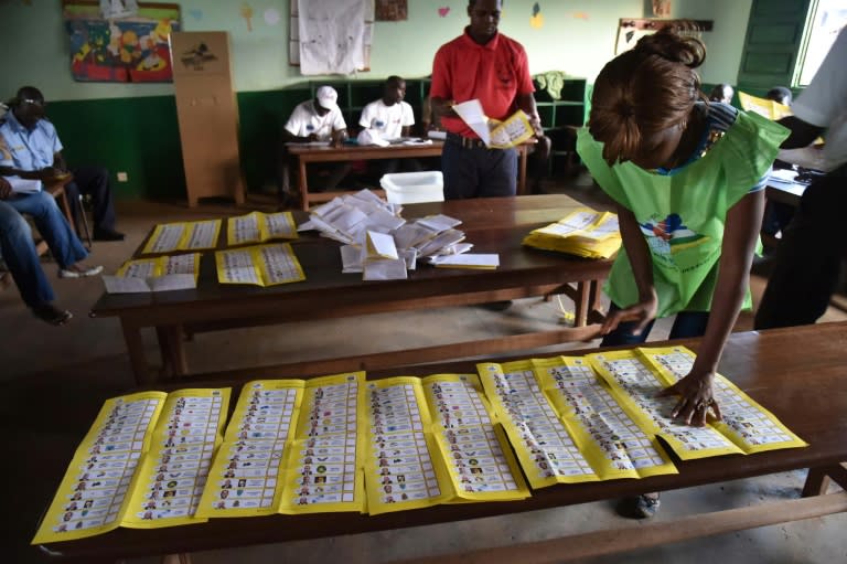 Election workers count votes after polls closed during the presidential and legislative elections in Bangui on December 30, 2015