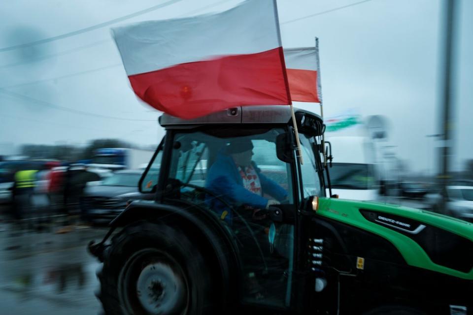 Over 100 farmers are blocking the road with their tractors, driving very slowly, in a protest against duty-free trade with Ukraine in Grojec, Poland, on Feb. 9, 2024. (Piotr Lapinski/NurPhoto via Getty Images)