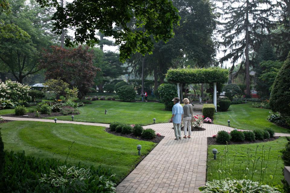 2023 Garden Walk attendees take in the beauty of a vibrant garden.
