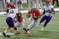 Ohio State quarterback Justin Fields (1) runs between Northwestern defenders Paddy Fisher (42) and Adetomiwa Adebawore (49) during the first half of the Big Ten championship NCAA college football game, Saturday, Dec. 19, 2020, in Indianapolis. (AP Photo/AJ Mast)