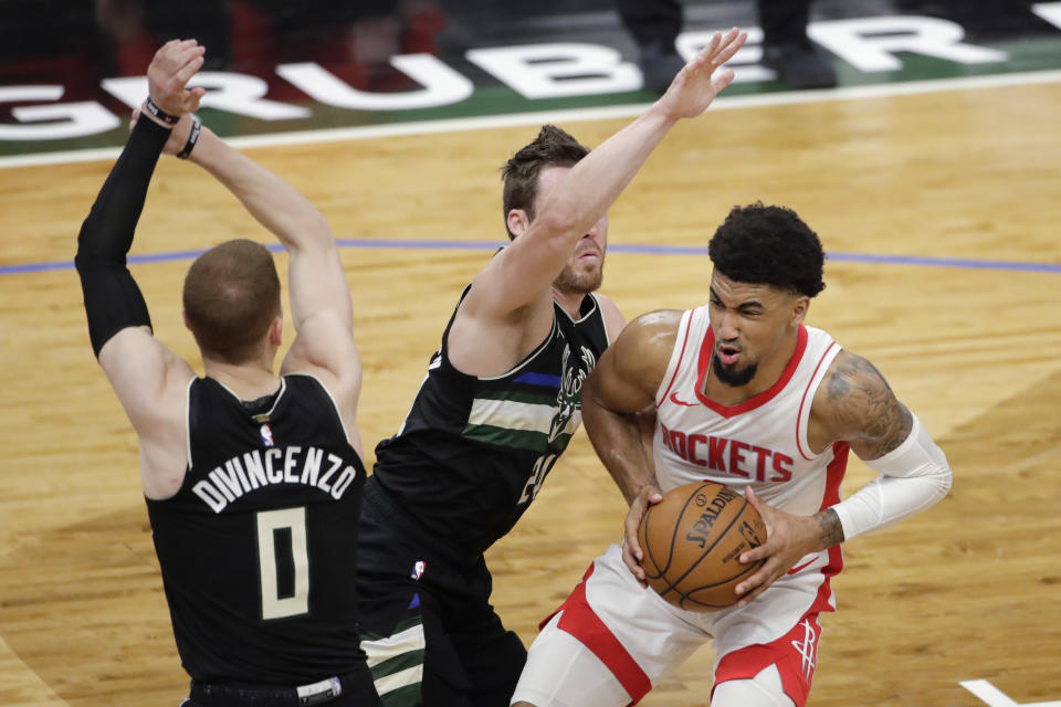 Houston Rockets' Kenyon Martin Jr., right, drives to the basket against Milwaukee Bucks' Pat Connaughton, middle, and Donte DiVincenzo, left, during the first half of an NBA basketball game Friday, May 7, 2021, in Milwaukee. (AP Photo/Aaron Gash)