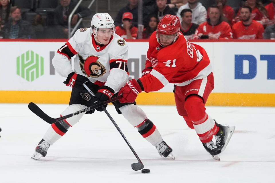 Senators center Ridly Greig shoots as Red Wings defenseman Shayne Gostisbehere defends in the third period of the Wings' 3-2 overtime loss to the Senators on Wednesday, Jan. 31, 2024, at Little Caesars Arena.