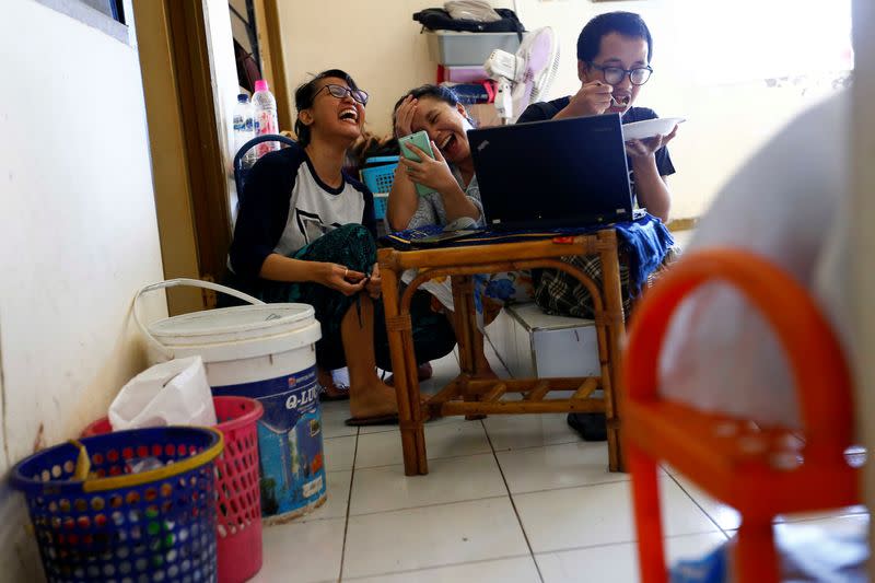 People make a video call with their family after prayers for Eid al-Fitr, the Muslim festival marking the end the holy fasting month of Ramadan, at a boarding house in Jakarta, Indonesia, amid the coronavirus disease (COVID-19) outbreak