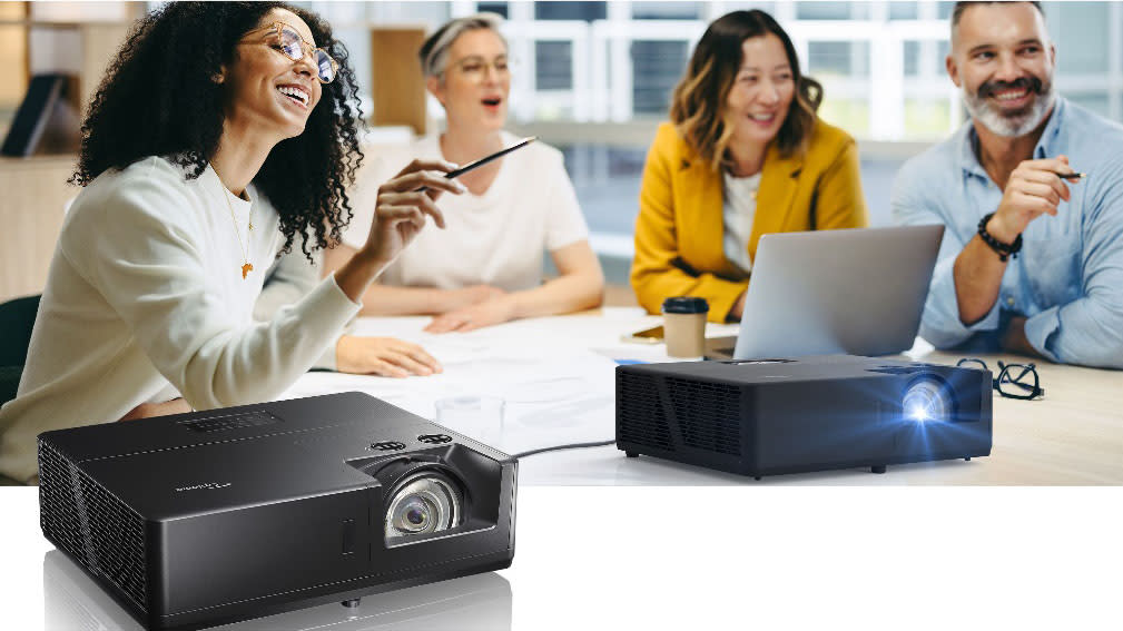  Smiling coworkers using New ZU607TST, ZU607T and ZU707T projectors from Optoma in a presentation. . 