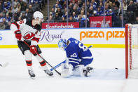 New Jersey Devils center Jack Hughes (86) scores on Toronto Maple Leafs goaltender Joseph Woll (60) during the third period of an NHL hockey game in Toronto on Tuesday, March 26, 2024. (Cole Burston/The Canadian Press via AP)