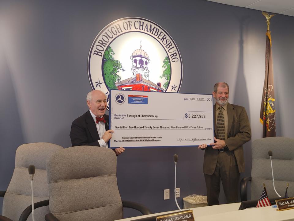 Chambersburg Borough Council President Allen Coffman, left, and Gas Superintendent John Leary show a big check representing the $5,227,953 grant from the Pipeline and Hazardous Materials Safety Administration.