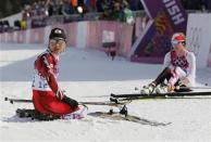 Japan's Masako Ishida (L) and Poland's Justyna Kowalczyk react after competing in the women's cross-country 30 km mass start free event at the Sochi 2014 Winter Olympic Games in Rosa Khutor February 22, 2014. REUTERS/Stefan Wermuth