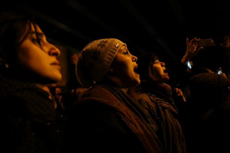 A woman shouts slogans as she gathers with people to show their sympathy to the victims of the crash of the Boeing 737-800 plane, flight PS 752, in Tehran