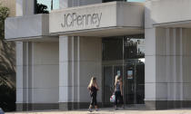 In this Wednesday, Aug. 14, 2019, photo two women walk into the JCPenney store in Peabody, Mass. J.C. Penney Co. on Thursday, Aug. 15, reported a loss of $48 million in its fiscal second quarter. (AP Photo/Charles Krupa)