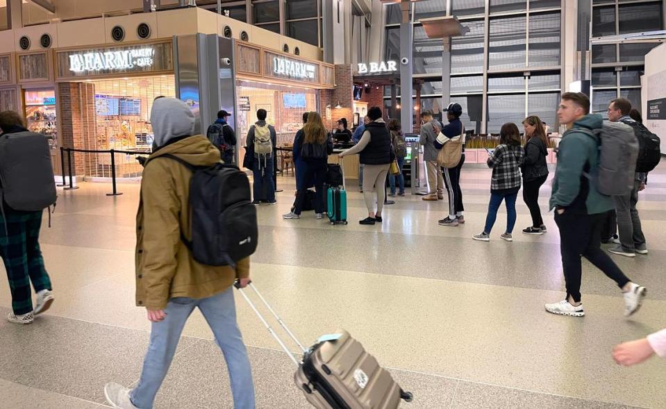 Passengers wait for La Farm Bakery and Cafe to open in Terminal 2 at Raleigh-Durham International Airport at 5:02 a.m. on February 17, 2024.