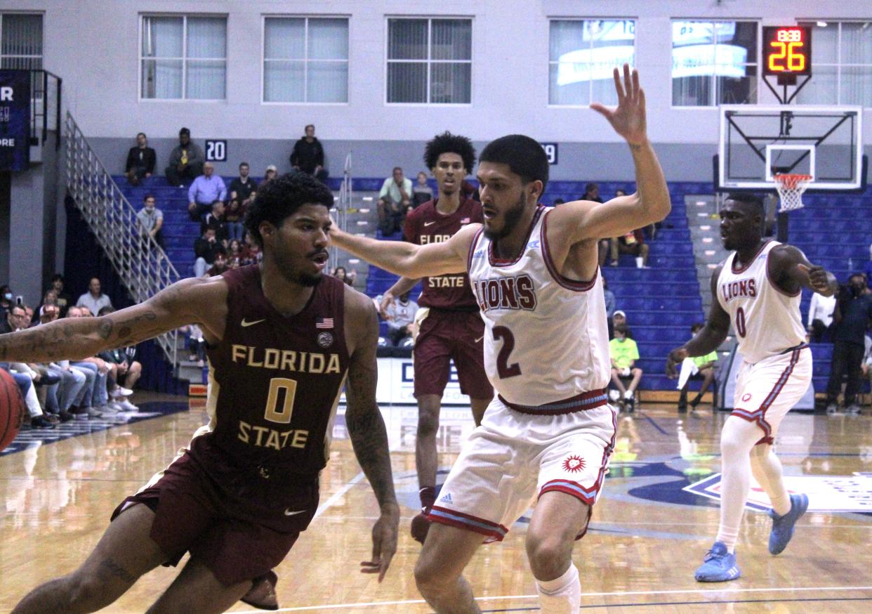 Florida State guard RayQuan Evans (0) dribbles as Loyola Marymount guard Joe Quintana (2) defends during Sunday night's Jacksonville Classic college basketball game at the University of North Florida's UNF Arena.