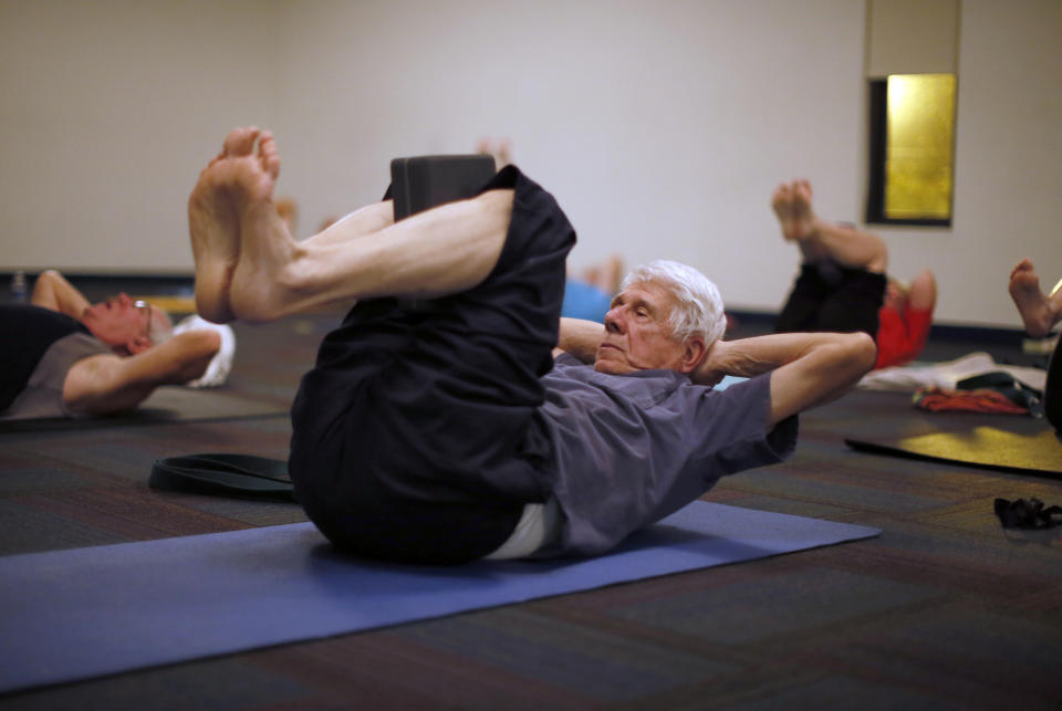 Retirees participate in a yoga class in Sun City, Arizona, January 7, 2013. Sun City was built in 1959 by entrepreneur Del Webb as America?s first active retirement community for the over-55's. Del Webb predicted that retirees would flock to a community where they were given more than just a house with a rocking chair in which to sit and wait to die. Today?s residents keep their minds and bodies active by socializing at over 120 clubs with activities such as square dancing, ceramics, roller skating, computers, cheerleading, racquetball and yoga. There are 38,500 residents in the community with an average age 72.4 years. Picture taken January 7, 2013.   REUTERS/Lucy Nicholson (UNITED STATES - Tags: SOCIETY TPX IMAGES OF THE DAY)    ATTENTION EDITORS - PICTURE 25 OF 30 FOR PACKAGE 'THE SPORTY SENIORS OF SUN CITY'  SEARCH 'SUN CITY' FOR ALL IMAGES