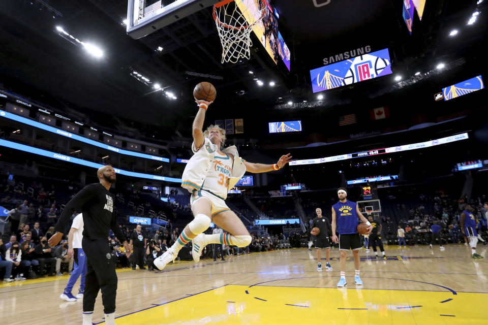 Actor Will Ferrell shoots as Golden State Warriors guard Klay Thompson, at free-throw line, watches before the team's NBA basketball game against the Los Angeles Clippers in San Francisco, Tuesday, March 8, 2022. (AP Photo/Jed Jacobsohn)