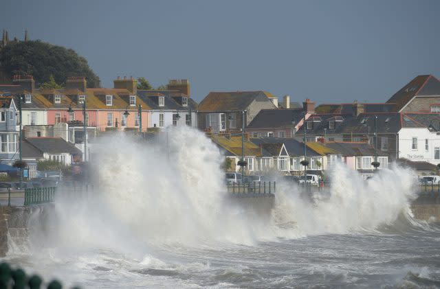 Waves break on the sea wall at Penzanze, Cornwall