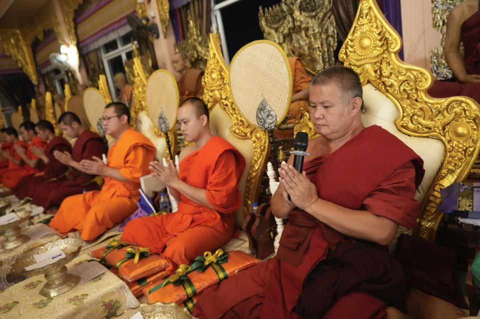 Thai Buddhist monks pray during a funeral ceremony at Wat Phra That Doi Wao temple in Chiang Rai province Thailand, Saturday, March 4, 2023. The cremated ashes of Duangphet, one of the 12 boys rescued from a flooded cave in 2018, arrived in the far northern Thai province of Chiang Rai on Saturday where final Buddhist rites for his funeral will be held over the next few days following his death in the U.K. (AP Photo/Sakchai Lalit)