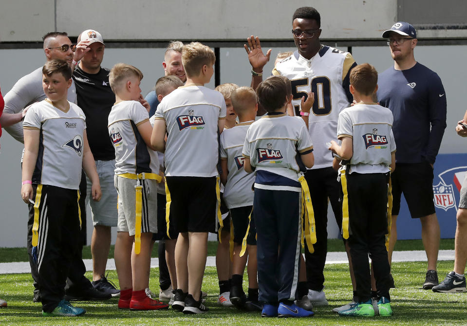 NFL player Samson Ebukam of the Los Angeles Rams coaches a young team during the final tournament for the UK's NFL Flag Championship, featuring qualifying teams from around the country, at the Tottenham Hotspur Stadium in London, Wednesday, July 3, 2019. The new stadium will host its first two NFL London Games later this year when the Chicago Bears face the Oakland Raiders and the Carolina Panthers take on the Tampa Bay Buccaneers. (AP Photo/Frank Augstein)