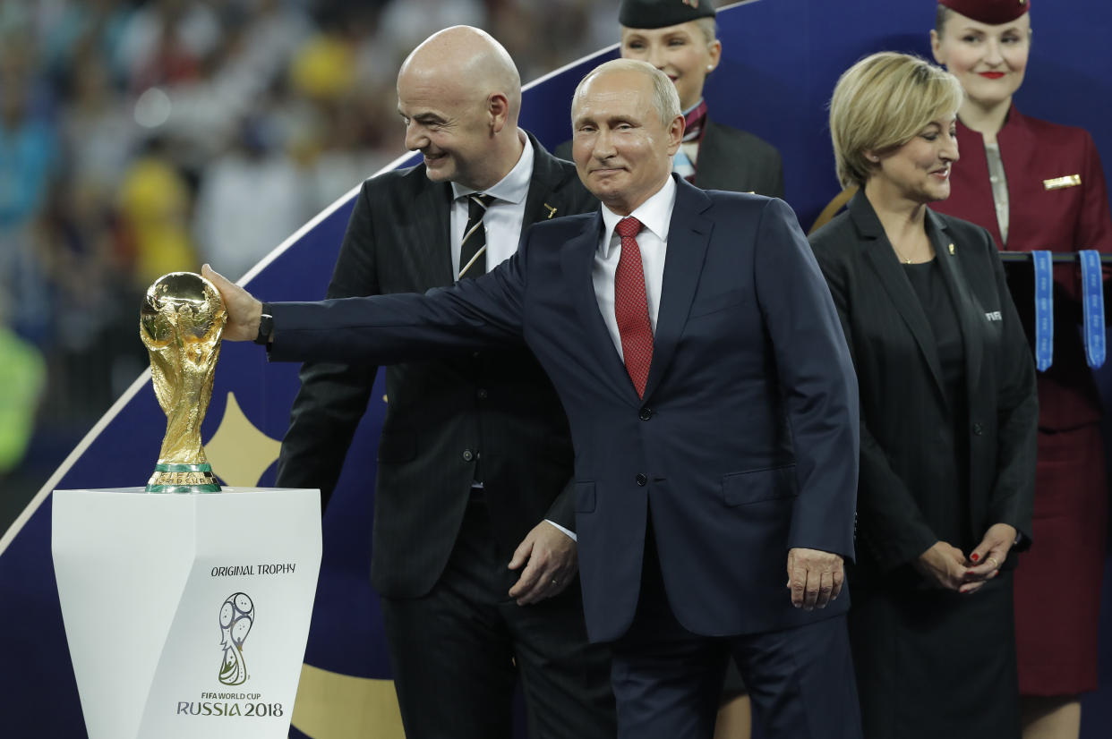 Russian President Vladimir Putin rubs the top of the trophy after the France v Croatia FIFA World Cup 2018 final at the Luzhniki Stadium on July 15th 2018 in Moscow, Russia (Photo by Tom Jenkins)