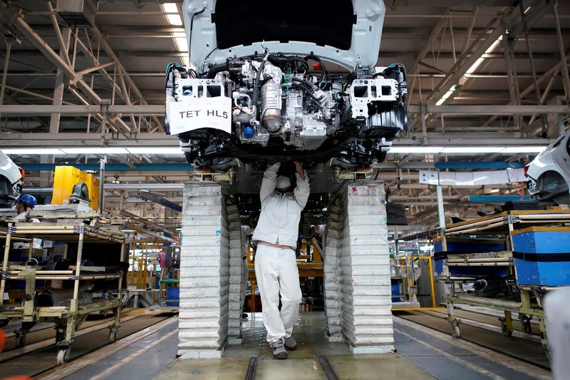 FILE PHOTO: Employee works on a production line inside a Dongfeng Honda factory in Wuhan