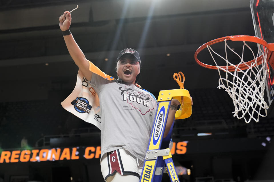 South Carolina guard Te-Hina Paopao (0) holds up a piece of the net after defeating Oregon State in an Elite Eight round college basketball game during the NCAA Tournament, Sunday, March 31, 2024, in Albany, N.Y. (AP Photo/Mary Altaffer)