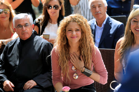 FILE PHOTO: Colombian singer Shakira reacts during her visit to Tannourine Cedars Reserve, in Tannourine, Lebanon July 13, 2018. REUTERS/Jamal Saidi