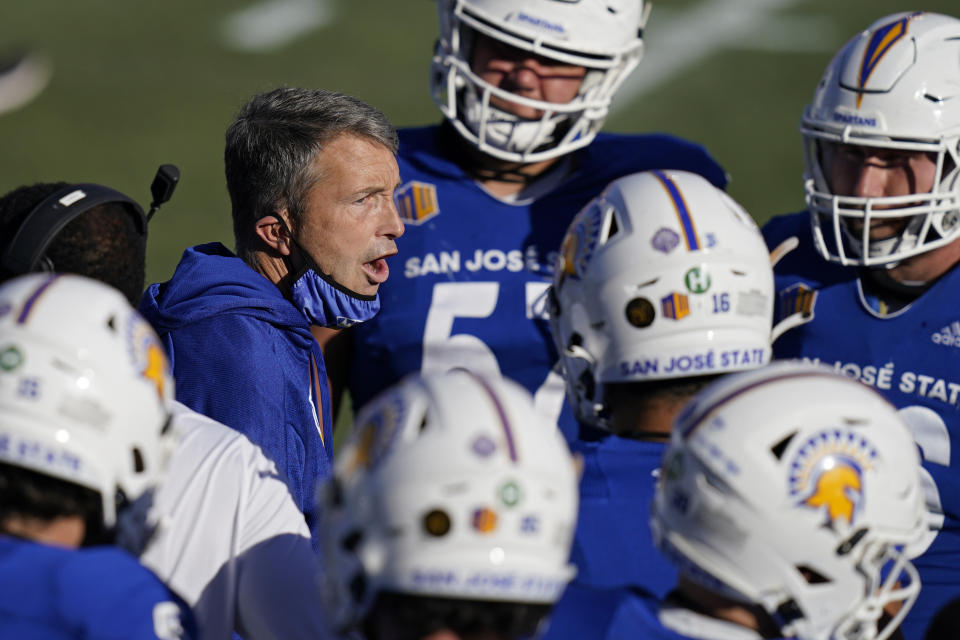 San Jose State head coach Brent Brennan speaks with his players during the first half of an NCAA college football game against Boise State for the Mountain West championship, Saturday, Dec. 19, 2020, in Las Vegas. (AP Photo/John Locher)