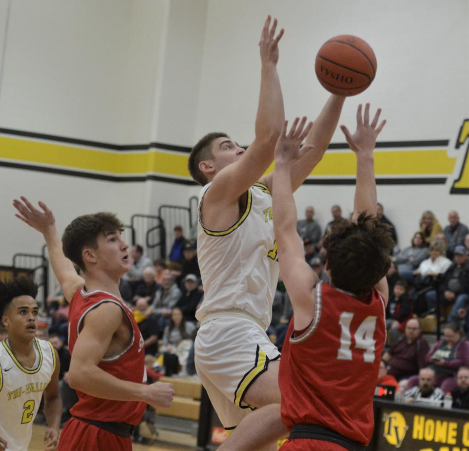 Tri-Valley's Erik Neal grabs a rebound over Sheridan's Reid Packer in Friday's MVL Big School Division game at Tri-Valley. The Scotties won 52-36.