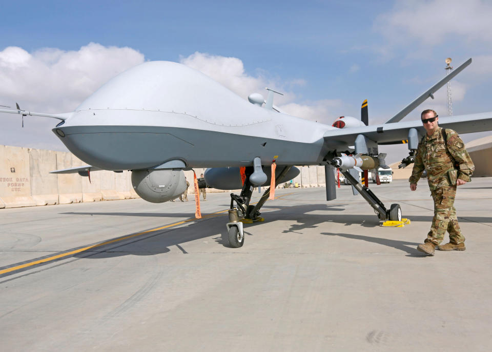 U.S. Air Force officer passes in front of a MQ-9 Reaper drone, one of a squadron that has arrived to step up the fight against the Taliban, at the Kandahar air base, Afghanistan January 23, 2018. REUTERS/Omar Sobhani